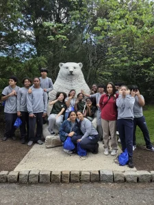 PCSST students posing beside a polar bear statue during their zoo trip
