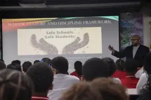 A staff member presents the “Safe Schools, Safe Students” message.