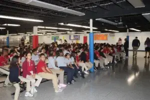 A large group of Grades 4–7 students gathers in the cafeteria for the school culture assembly.