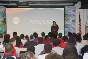 A staff member introduces the School Culture and Discipline Framework to students in grades 4 through 7.